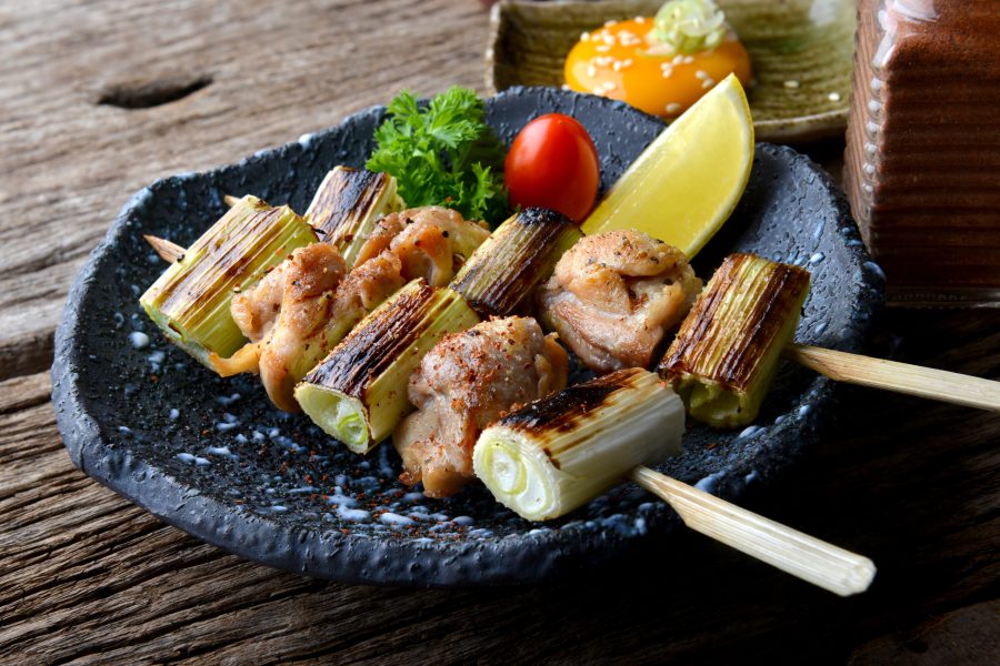 Nekima yakitori or Japanese chicken and onion in bamboo skewer grilled with charcoal fire serve in izakaya reataurant.